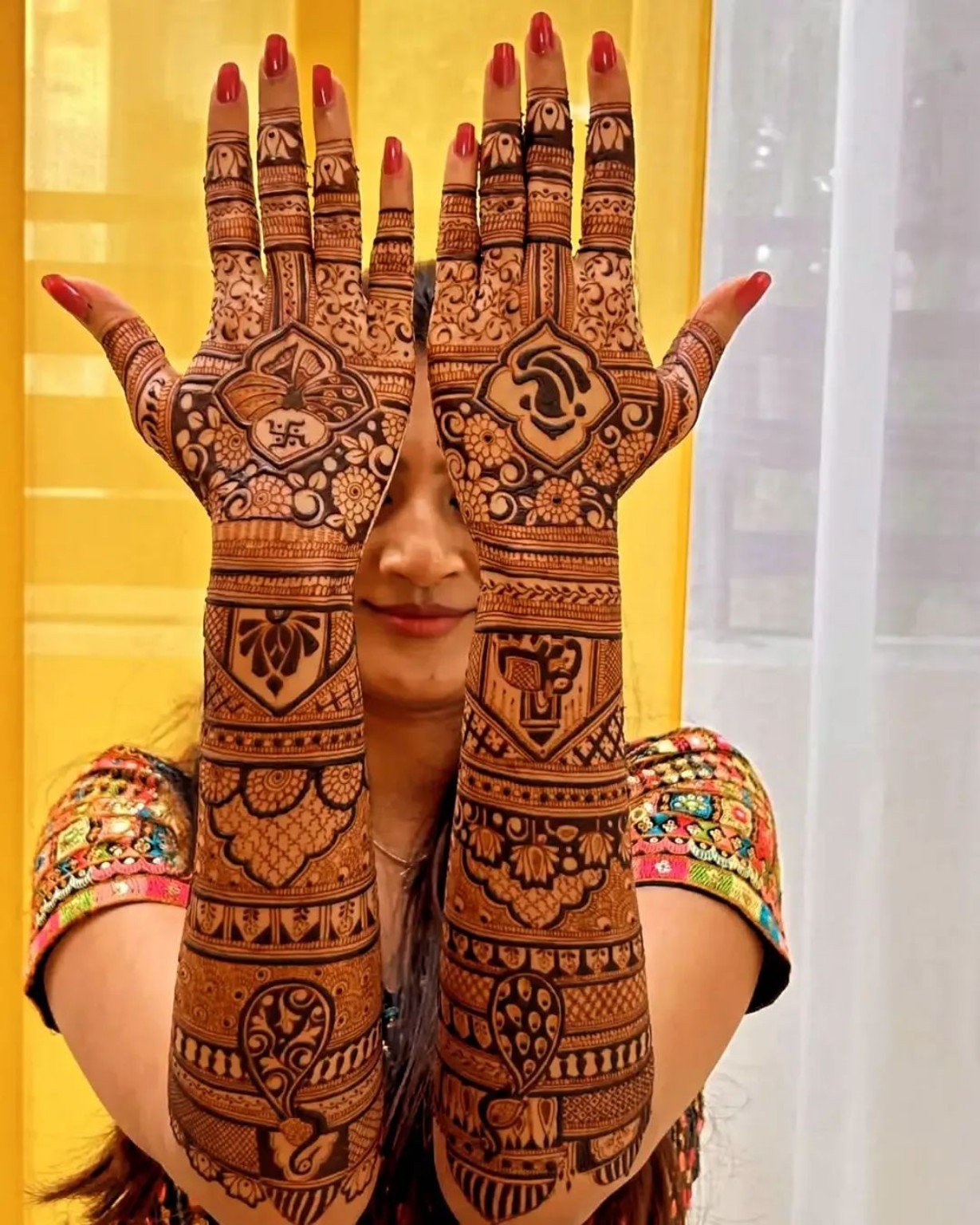 Detailed mehndi on both palms and arms